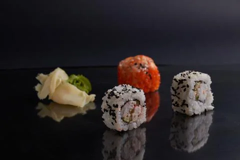 Several different rolls on the table, asian food, side view, dark background Stock Photos