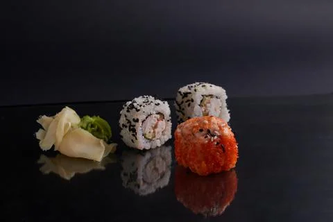 Several different rolls on the table, asian food, side view, dark background Stock Photos