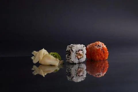 Several different rolls on the table, asian food, side view, dark background Stock Photos