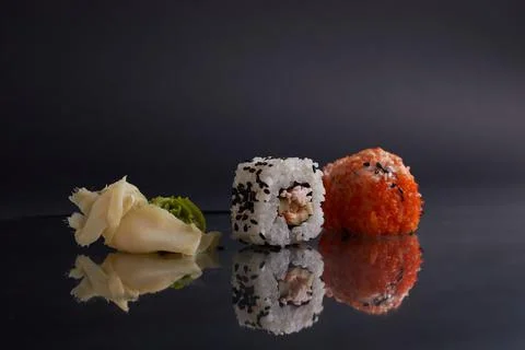 Several different rolls on the table, asian food, side view, dark background Stock Photos