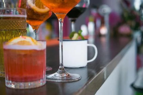 Several different smoothies in glasses of different shapes on the bar counter 写真素材
