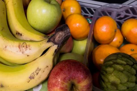 Several different types of fresh slightly spoiled fruits found in the local o Stock Photos