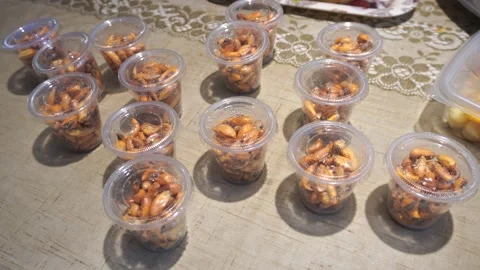 Several disposable cups with corn nut inside brought by food delivery on a table Stock Footage 154812357