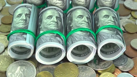 Several of dollar banknotes in rolls with rubber bands and coins on table 스톡 동영상 131503114