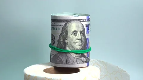 Several of dollar banknotes in rolls with rubber bands and coins on table Stock Footage 131503129