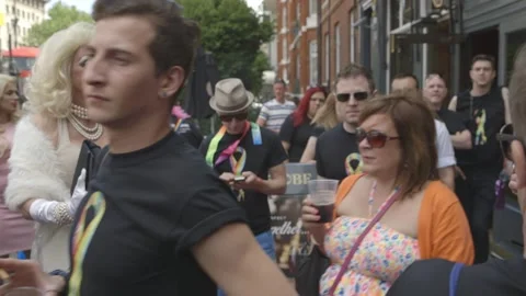 SEVERAL DRAG QUEENS SMILING AMONGST THE CROWDS AT PRIDE IN LONDON PARADE Stock Footage 130742859