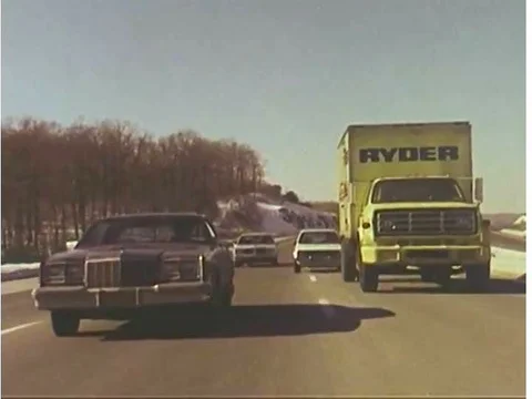 Several drivers nearly collide on a throughway, in 1982. Stock Footage 75410437