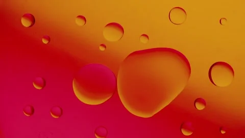 Several drops connect together on a red and yellow gradient background. 스톡 동영상 303059169