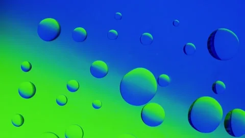 Several drops join together on a blue-green gradient background. 스톡 동영상 303059521