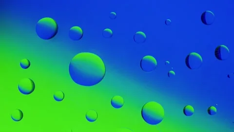 Several drops join together on a blue-green gradient background. Видео 303059635