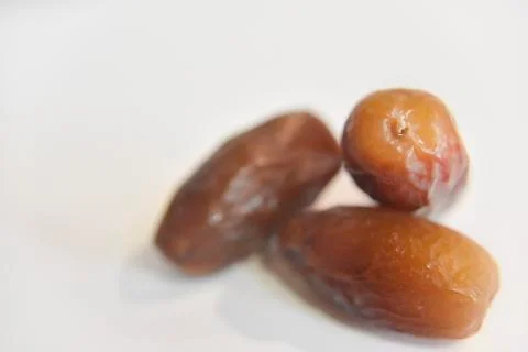 Several dry dates on the white background Stock Photos