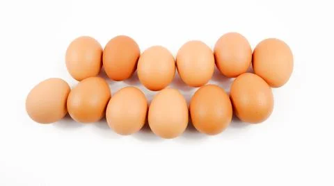 Several eggs are placed on a white background. Stock Photos