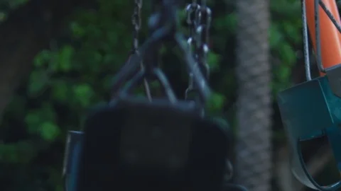 Several empty moving swings at playground Stock Footage 122183592