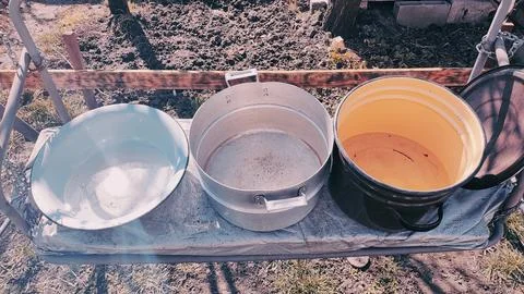 Several empty pans. large pots of water. many colorful pots. Stock Photos