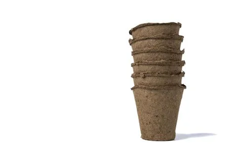 Several empty peat pots for seedlings inserted one into the other isolated on Stock Photos