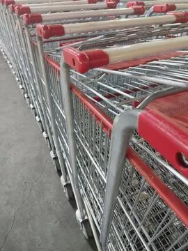 Several empty supermarket carts lined up Stock Photos