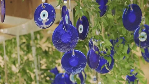 Several evil eye decor hanging from the ceiling mixed with tree branches. Video stock 201105434