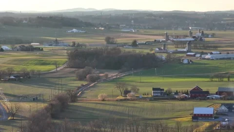 Several farmsteads with barn and silo storage in rural countryside of Stock Footage 300498929