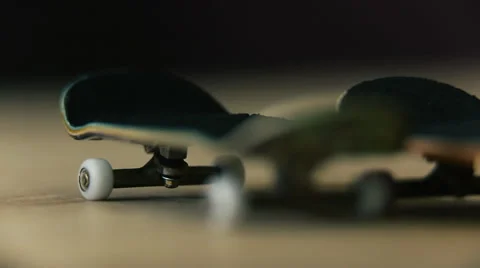 Several fingerboards lie on a wooden table Stock Footage 59963053