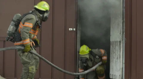 Several Fire Fighters working a burning building Video stock 57214637