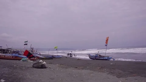 Several fishermen are seen pulling their boats out of the sea Stock Footage 276913712