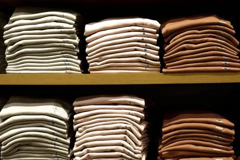 Several folds. Basic cotton t-shirts presented in rustic interiors. Stock Photos