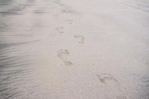 Several footprints on the beach Stock Photos