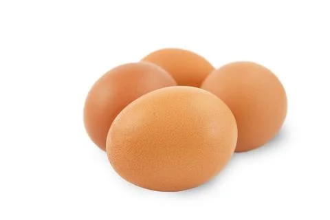 Several fresh brown eggs isolated on a white background. Stock Photos