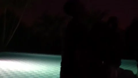 Several friends having drinks at a pool party at night Stock Footage 170014507