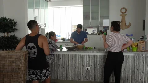 Several friends in the kitchen serving mussels a la chalaca with tomato and Stock-Footage 192891050
