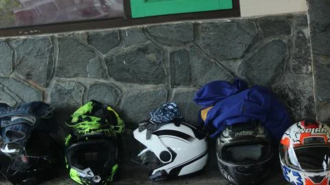 Several full-cafe helmets and half-face helmets were placed on the table Stock Photos