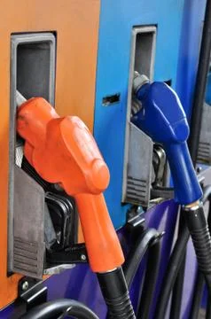 Several gasoline pump nozzles at petrol station, gasoline industry Stock Photos