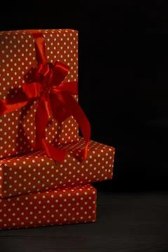 Several gift boxes packed in red paper on a wooden background Stock Photos