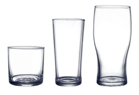 Several glasses for drinks of different shapes and sizes isolated on a white Stock Photos