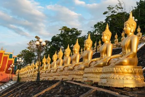 Several golden buddhas aligned Pakse Stock Photos