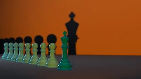 Several green Chess Pawns lined up with the Chess King at the forefront, the Stock Illustration