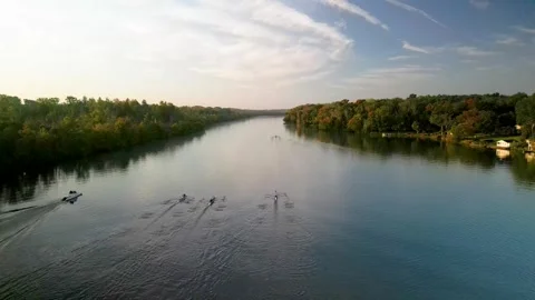 Several groups of rowers training on a calm lake at sunrise Stock Footage 287361542