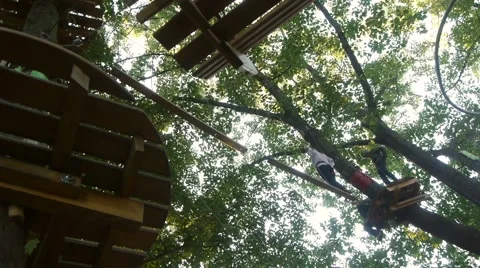 Several high-wire in the complex area of high-altitude route in the ropes course Stock Footage 68209584