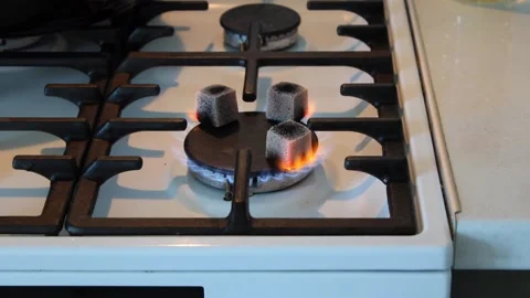 Several hookah coals are burning on a gas stove Stock Footage 311663928