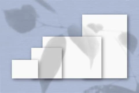 Several horizontal and vertical sheets of white textured paper against a blue Stock Illustration