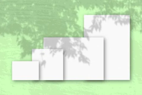 Several horizontal and vertical sheets of white textured paper against a gree Stock Illustration