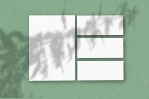 Several horizontal and vertical sheets of white textured paper against a green Illustrazione stock