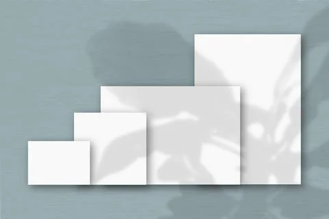 Several horizontal and vertical sheets of white textured paper against a grey Stock Illustration