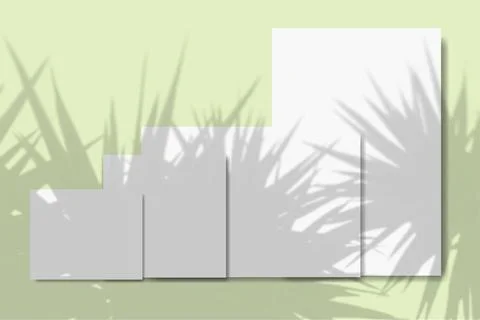 Several horizontal and vertical sheets of white textured paper against a green Stock Illustration