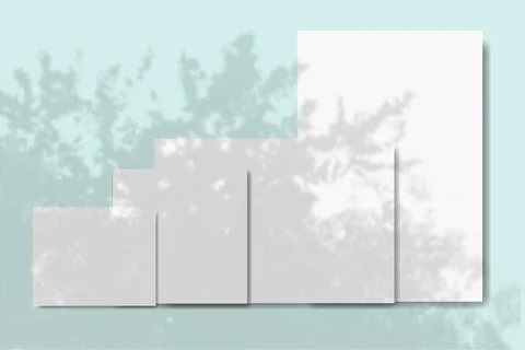 Several horizontal and vertical sheets of white textured paper against a blue Stock Illustration