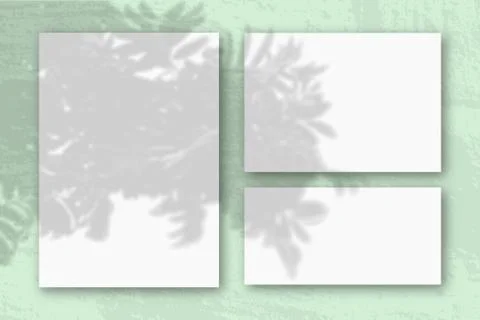 Several horizontal and vertical sheets of white textured paper against a blue Stock Photos