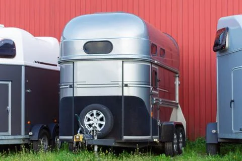 Several horse transportation trailers parked on the grass Stock Photos