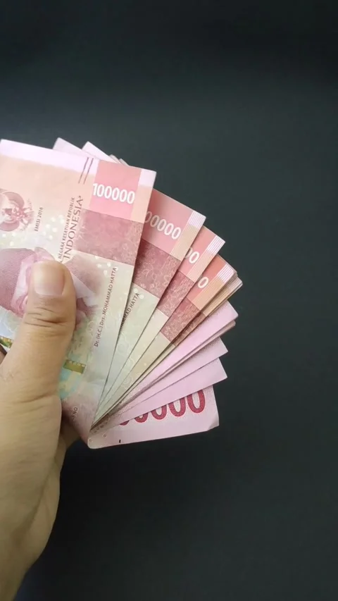 Several hundred thousand rupiah bills in hand Stock Footage 221620845