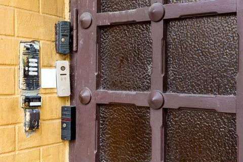 Several intercoms and electronic locks on a chip or card on brick wall. Stock Photos