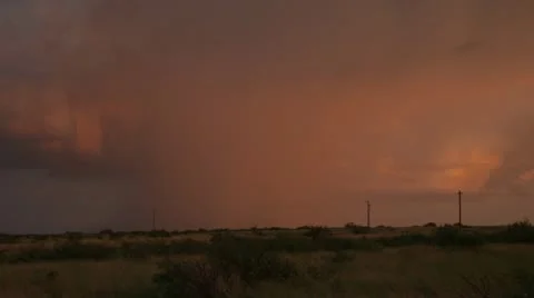Several jagged flashes of forked lightning strike from a storm at sunset. Stock Footage 11406932